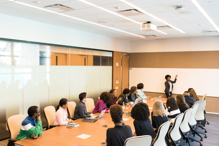 A woman teaching a lecture in a small classroom