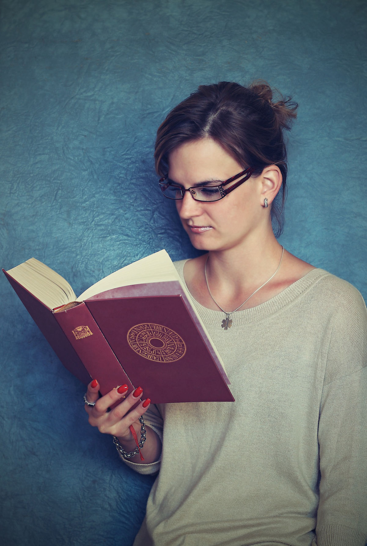 A woman with glasses reading a book