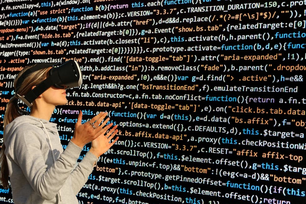 A woman with VR goggles on looking at a wall of computer code