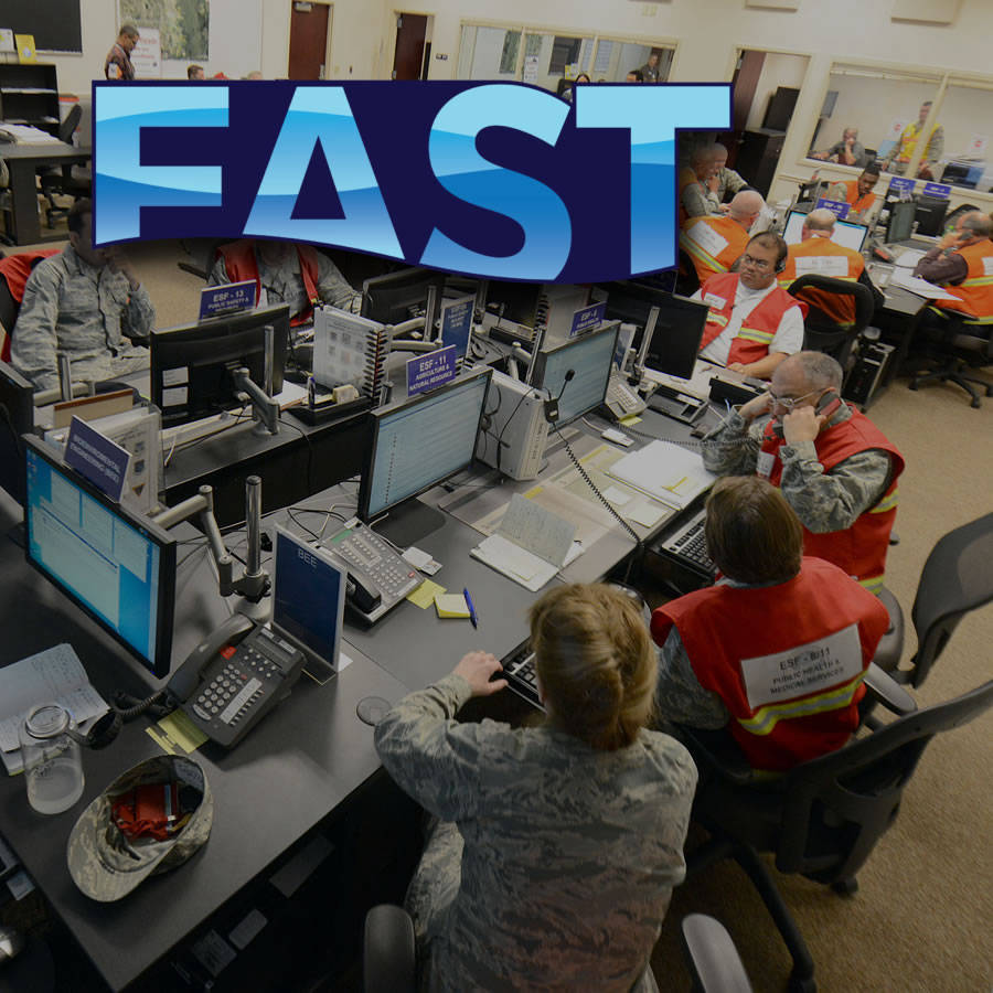 Control room with staff at computer stations and 'FAST' logo prominently displayed, symbolizing a flood awareness and response tool.